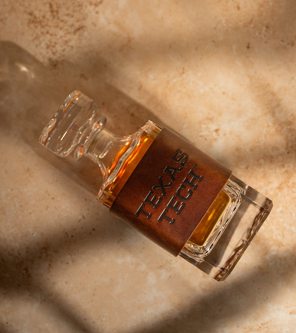 Close-up of a decanter with a premium leather wrap displaying 'Texas Tech' 