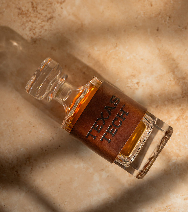 Close-up of a decanter with a premium leather wrap displaying &