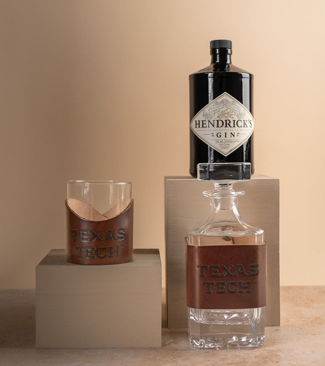 Glass decanter and rocks glasses with premium leather wraps featuring &